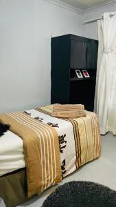 a room with two beds with a blanket on it at 52Golfcourseview guest house in Pimville