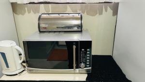 a microwave sitting on top of a counter at 52Golfcourseview guest house in Pimville