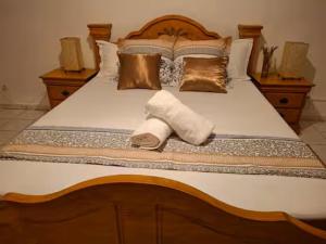 a bed with two rolled up towels on it at Case Kiyas in Mamoudzou