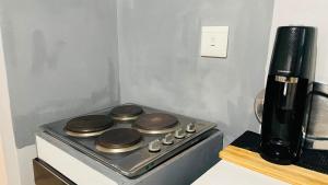 a stove top oven sitting on top of a counter at 52Golfcourseview guest house in Pimville
