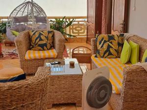 a living room with two chairs and a table at Case Kiyas in Mamoudzou