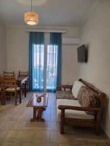 a living room with a couch and a table at Diogenes Apartments in Samos