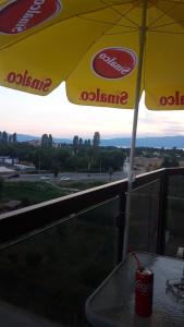 a drink sitting on a table under an umbrella at Lychnidos Residence 2 in Ohrid