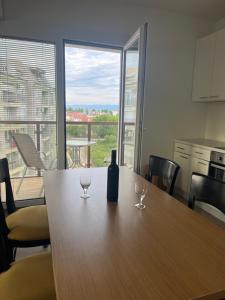 a bottle of wine sitting on a table with two wine glasses at Lychnidos Residence 2 in Ohrid +4 photos