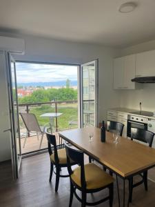 a kitchen and dining room with a table and chairs at Lychnidos Residence 2 in Ohrid