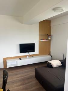 a living room with a tv on a wall at Lychnidos Residence 2 in Ohrid