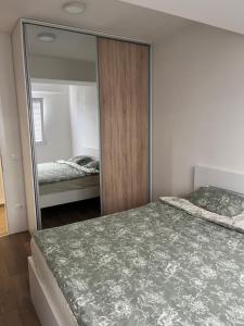 a bedroom with a large mirror and a bed at Lychnidos Residence 2 in Ohrid