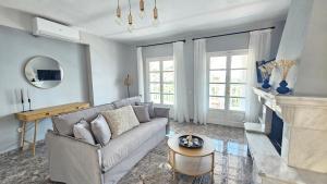 a living room with a couch and a fireplace at Κάρτ Ποστάλ Τρίκερι- Carte Postale Trikeri in Trikeri