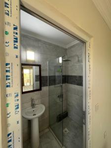 a bathroom with a sink and a glass shower at Narçiçeği in Değirmendere