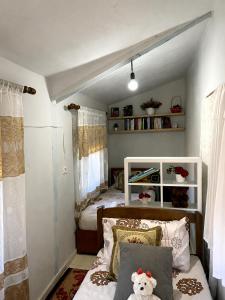 a bedroom with a bed with a teddy bear on it at Koman Rest Point in Koman
