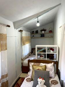 a bedroom with a bed with a teddy bear on it at Koman Rest Point in Koman