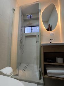a bathroom with a shower with a toilet and a sink at Rincón Familiar Hotel Boutique in Quito +76 photos