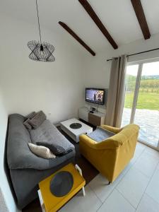a living room with a couch and a tv at Villa Noor Visoko in Visoko