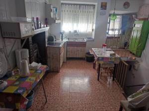a kitchen with two tables and a sink in it at Casa Solana in Cambil