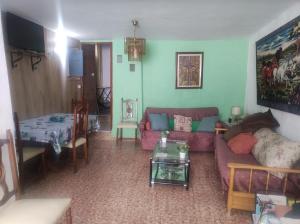 a living room with a couch and a table at Casa Solana in Cambil