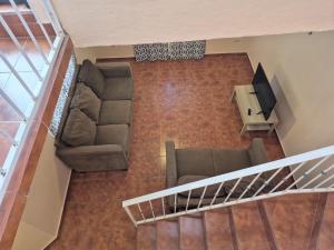 an overhead view of a living room with a couch and a television at Bugambilias Condo D with Pool and Beach Access - Rancho Bugambilias in San Felipe
