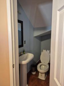 a bathroom with a white toilet and a sink at Bugambilias Condo D with Pool and Beach Access - Rancho Bugambilias in San Felipe +12 photos