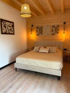a bedroom with a bed in a wooden room at Gîte Chalet Bellevue in Couvin +57 photos