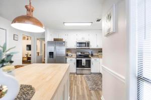 a kitchen with white appliances and a wooden counter top at Greenway Oasis 3BR home in Hidden Oaks