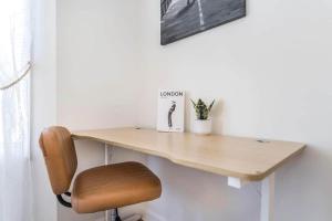 a wooden desk with a chair in a room at Greenway Oasis 3BR home in Hidden Oaks +27 photos