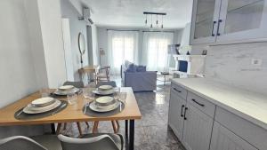 a kitchen with a table with plates on it at Κάρτ Ποστάλ Τρίκερι- Carte Postale Trikeri in Trikeri