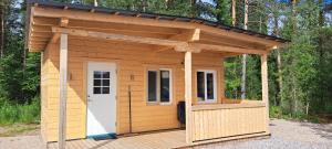 a small shed with a roof on a wooden deck at Single room - small cabin - stuga - self check in - Gällivare Koskullskulle in Koskullskulle
