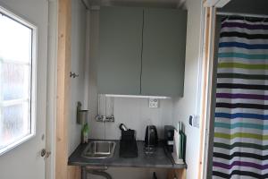 a small kitchen with a sink and a counter top at Single room - small cabin - stuga - self check in - Gällivare Koskullskulle in Koskullskulle