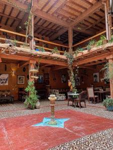 a large patio with a table and chairs in a building at Riad Espace Asrir Tiznit in Tiznit