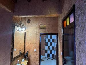 a bathroom with a mirror and a door with a dog on it at Riad Espace Asrir Tiznit in Tiznit +34 photos
