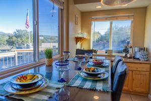 a dining room with a glass table with food on it at Serenity at Rimrock in Rimrock