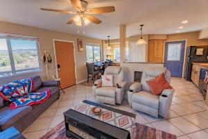 a living room with a couch and chairs and a kitchen at Serenity at Rimrock in Rimrock