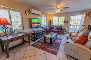 a living room with a couch and a tv at Serenity at Rimrock in Rimrock +30 photos