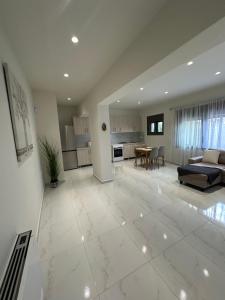 a large living room with a couch and a table at Eleonora apartment in Porto Rafti