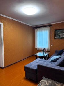 a living room with a couch and a window at Sweet Home 3 in Sevan +4 photos