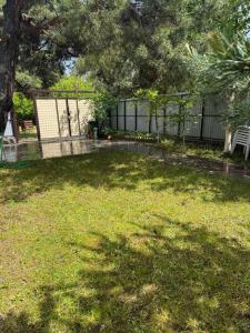 a yard with a fence and a bench in the grass at Sweet Home 3 in Sevan