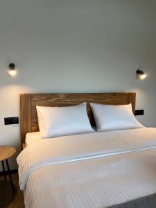 a bed with two white pillows in a room at Sviy home in Slavske