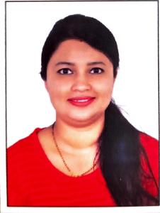 a woman wearing a red shirt and a necklace at Wayanad Villa in Wayanad