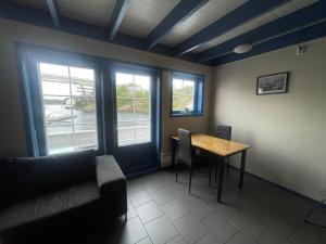 a room with a table and chairs and windows at Nautnes Costal Heaven in Nautnes
