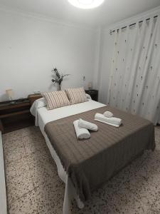 a bedroom with a bed with two towels on it at Casa la parra in Ardales
