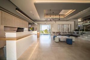 a lobby with a living room and a dining room at Harmony Crest Resort in Kos