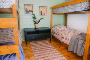 a bedroom with two bunk beds and a table with a plant at Värska kämping in Värska +32 photos