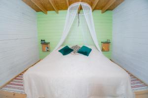 a bed with a white canopy in a room at Värska kämping in Värska