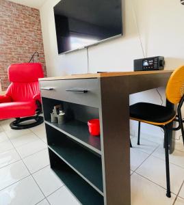 a desk in a room with a red chair at LohainsLodge in Burbach