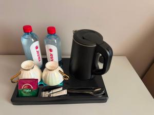a black coffee maker on a tray on a table at Sapar de lux hotel in Qyzylorda