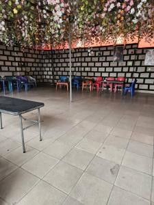 a room with a table and chairs and flowers at GRACECUT HOTEl in Enugu