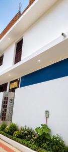 a white and blue building with a sign on it at Hotel Panchmukhi Ashram Ayodhya Dham in Ayodhya +4 photos