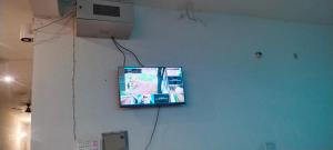 a flat screen tv hanging on a wall at Hotel Panchmukhi Ashram Ayodhya Dham in Ayodhya
