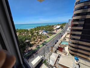 a view of the beach from a balcony of a building at Lindo Duplex na orla de Pajuçara in Maceió +47 photos