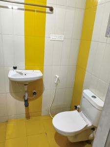 a bathroom with a toilet and a sink at Kmr villa in Madurai