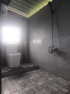 a bathroom with a shower with a toilet at Rimaaia homestay in Lāitlyngkot